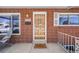 Front door with security door and a welcome mat at 2994 S Winona Ct, Denver, CO 80236