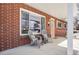 Front porch with two gray chairs and a welcome mat at 2994 S Winona Ct, Denver, CO 80236