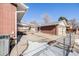 Attached brick garage with double doors and a chain link fence at 2994 S Winona Ct, Denver, CO 80236