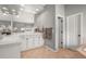 Bright bathroom with white cabinets, neutral tile floors, and a large mirror at 907 Greenridge Ln, Castle Pines, CO 80108