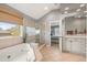 Bathroom featuring a soaking tub, a walk-in shower and ample natural light at 907 Greenridge Ln, Castle Pines, CO 80108