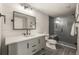 Bathroom features a modern vanity with a large mirror and a tiled shower at 907 Greenridge Ln, Castle Pines, CO 80108