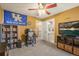Bright bedroom with desk area, decorated with blue collegiate theme and connected bath at 907 Greenridge Ln, Castle Pines, CO 80108