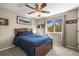 Comfortable bedroom with natural light, ceiling fan, and sporty decor at 907 Greenridge Ln, Castle Pines, CO 80108