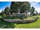 Inviting entrance sign to Forest Park community, surrounded by lush landscaping and greenery at 907 Greenridge Ln, Castle Pines, CO 80108