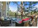 Outdoor deck with comfortable seating and views of the surrounding trees at 907 Greenridge Ln, Castle Pines, CO 80108