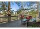 Spacious outdoor deck with patio furniture and view of landscaped backyard at 907 Greenridge Ln, Castle Pines, CO 80108