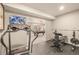 Bright exercise room equipped with a treadmill and weight training equipment at 907 Greenridge Ln, Castle Pines, CO 80108