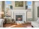 A cozy fireplace with white mantle and gray herringbone tile at 907 Greenridge Ln, Castle Pines, CO 80108