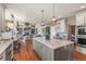 Open-concept kitchen with center island flows into the living area, ideal for entertaining at 907 Greenridge Ln, Castle Pines, CO 80108