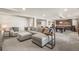 Open-concept living room with neutral colors, and a partial view of kitchenette at 907 Greenridge Ln, Castle Pines, CO 80108