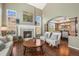 Living room with fireplace, hardwood floors, and large windows at 907 Greenridge Ln, Castle Pines, CO 80108