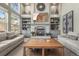 Elegant living room featuring a cozy fireplace, built-in shelving, and comfortable seating at 907 Greenridge Ln, Castle Pines, CO 80108
