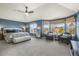 Large primary bedroom with sitting area, bay window, and neutral carpet at 907 Greenridge Ln, Castle Pines, CO 80108