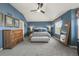 Spacious main bedroom featuring blue walls, vaulted ceiling, and a cozy sitting area at 907 Greenridge Ln, Castle Pines, CO 80108