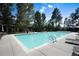 Refreshing swimming pool with lounge chairs and mature trees, perfect for relaxation and recreation at 907 Greenridge Ln, Castle Pines, CO 80108
