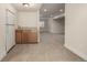 Basement kitchenette with cabinets, countertop, fridge, and finished floors at 16434 Homestead Ct, Parker, CO 80134