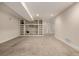 Spacious finished basement with recessed lighting, built-in shelves, and carpeted floors at 16434 Homestead Ct, Parker, CO 80134