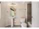 Bathroom with pedestal sink, toilet, and tiled tub/shower at 16434 Homestead Ct, Parker, CO 80134