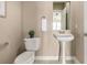 Charming powder bathroom with pedestal sink and neutral color palette at 16434 Homestead Ct, Parker, CO 80134