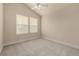 Bright, carpeted bedroom with vaulted ceiling, ceiling fan, and two windows at 16434 Homestead Ct, Parker, CO 80134