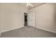 Neutral carpeted bedroom featuring ceiling fan and closet with bifold doors at 16434 Homestead Ct, Parker, CO 80134