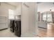 Convenient laundry room with modern washer and dryer units, plus built-in storage cabinets at 16434 Homestead Ct, Parker, CO 80134