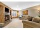 Inviting living room featuring a fireplace, plush carpeting, and comfortable seating at 13215 Holly St # E, Thornton, CO 80241