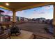 Spacious backyard with covered patio, string lights, and a serene outdoor space at 26322 E 2Nd Ave, Aurora, CO 80018