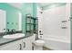 Bathroom featuring sleek, modern finishes with a shower-tub combination and coordinated black fixtures at 26322 E 2Nd Ave, Aurora, CO 80018