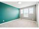 Bedroom with light gray carpet, light gray and green painted walls, and bright windows at 26322 E 2Nd Ave, Aurora, CO 80018