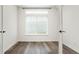 Bedroom featuring hardwood floors, a window, and white walls at 26322 E 2Nd Ave, Aurora, CO 80018