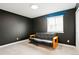Bedroom with a black futon couch and a large window that lets in plenty of natural light at 26322 E 2Nd Ave, Aurora, CO 80018