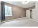 A bright bedroom with a window and sliding closet doors, offers a serene and organized space at 26322 E 2Nd Ave, Aurora, CO 80018