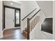 Bright entryway with hardwood floors, a staircase, and a view of the front door and front yard at 26322 E 2Nd Ave, Aurora, CO 80018
