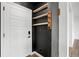 Entryway with hardwood floors, a white door, and wooden shelving at 26322 E 2Nd Ave, Aurora, CO 80018