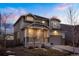 Inviting two-story home with a covered porch, stone detailing, and an attached two-car garage at 26322 E 2Nd Ave, Aurora, CO 80018