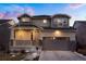 Charming two-story home featuring stone accents, covered front porch, and attached two-car garage at 26322 E 2Nd Ave, Aurora, CO 80018