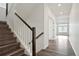 Hallway with hardwood floors and stairs leading up to the second level of the home at 26322 E 2Nd Ave, Aurora, CO 80018