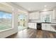 Bright kitchen with white cabinets, stainless steel appliances, and access to a patio at 26322 E 2Nd Ave, Aurora, CO 80018
