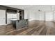 Modern kitchen with a stainless steel refrigerator, island with bar top, and wood flooring at 26322 E 2Nd Ave, Aurora, CO 80018