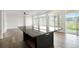 Kitchen island with dark countertop and stainless steel appliances at 26322 E 2Nd Ave, Aurora, CO 80018