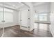 Bright living room featuring hardwood floors, large windows, and an open floor plan at 26322 E 2Nd Ave, Aurora, CO 80018