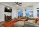 Cozy living room with a ceiling fan, a comfortable sofa, and large windows offering plenty of natural light at 26322 E 2Nd Ave, Aurora, CO 80018