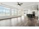 Spacious living room with hardwood floors, large windows, and an open layout to the kitchen at 26322 E 2Nd Ave, Aurora, CO 80018