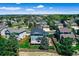 Aerial view featuring a beautiful home with deck and fence, nestled in a quiet neighborhood surrounded by trees at 11575 Wilson Cir, Parker, CO 80134