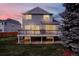 Exterior backyard shot of home highlighting deck, yard, and twilight at 11575 Wilson Cir, Parker, CO 80134