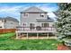 The backyard of the home features a spacious deck, grassy area, and mature landscaping at 11575 Wilson Cir, Parker, CO 80134