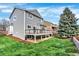 Back exterior view featuring a backyard with a deck, lawn, and tree at 11575 Wilson Cir, Parker, CO 80134