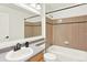 Traditional bathroom with tan tiled wall, bathtub and large vanity mirror at 11575 Wilson Cir, Parker, CO 80134